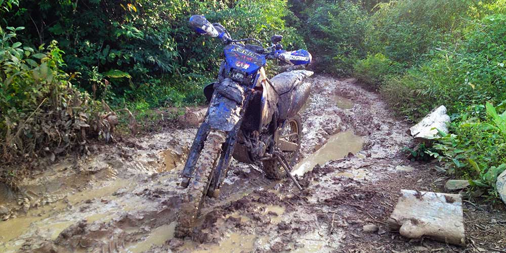 Muddy, rutted section on the way to Preah Khan... WR covered in mud